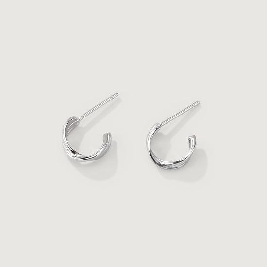 Pair of silver hoop earrings on a light gray background
