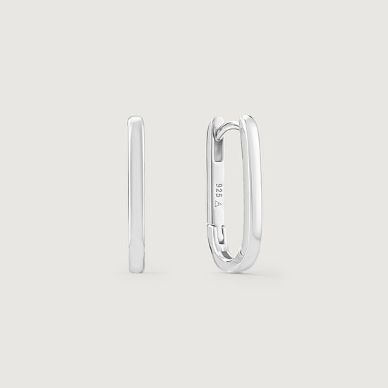 Silver hoop earrings on a light gray background