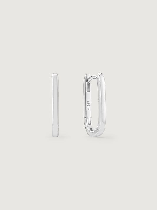 Silver hoop earrings on a light gray background