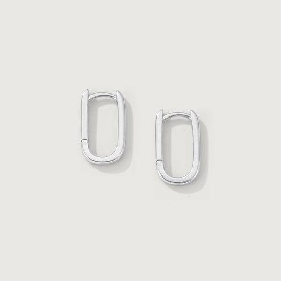 Pair of silver hoop earrings on a light gray background