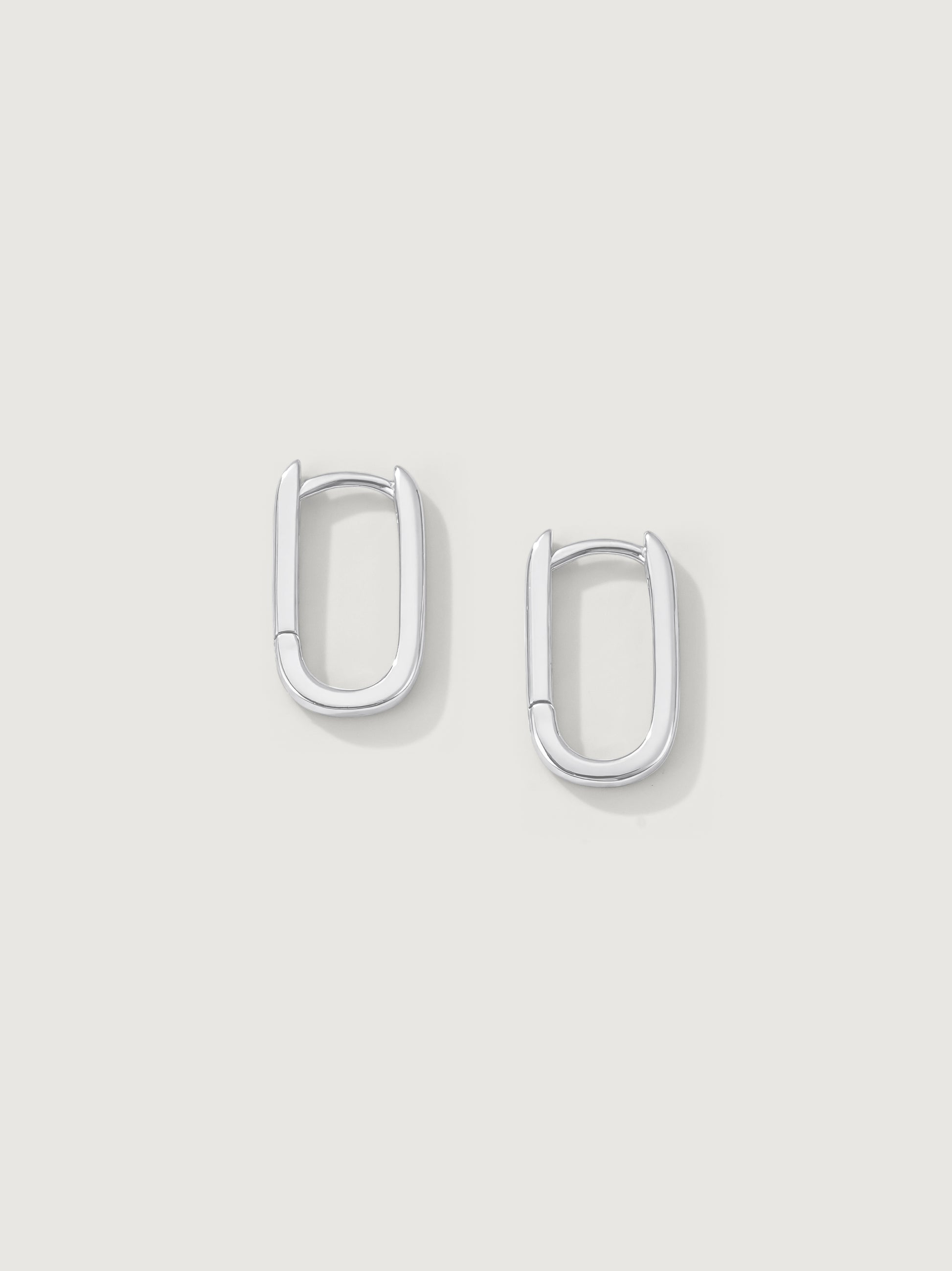Pair of silver hoop earrings on a light gray background