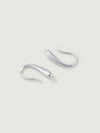 Pair of silver dune hoop earrings on a light gray background