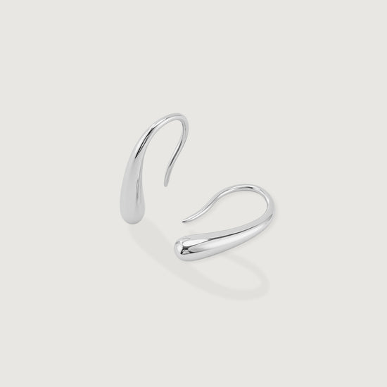 Pair of silver hoop earrings on a light gray background