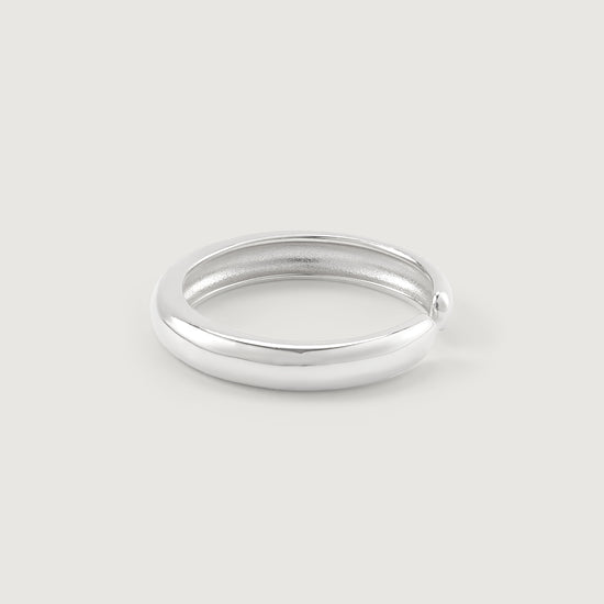 Silver ring on a light gray background