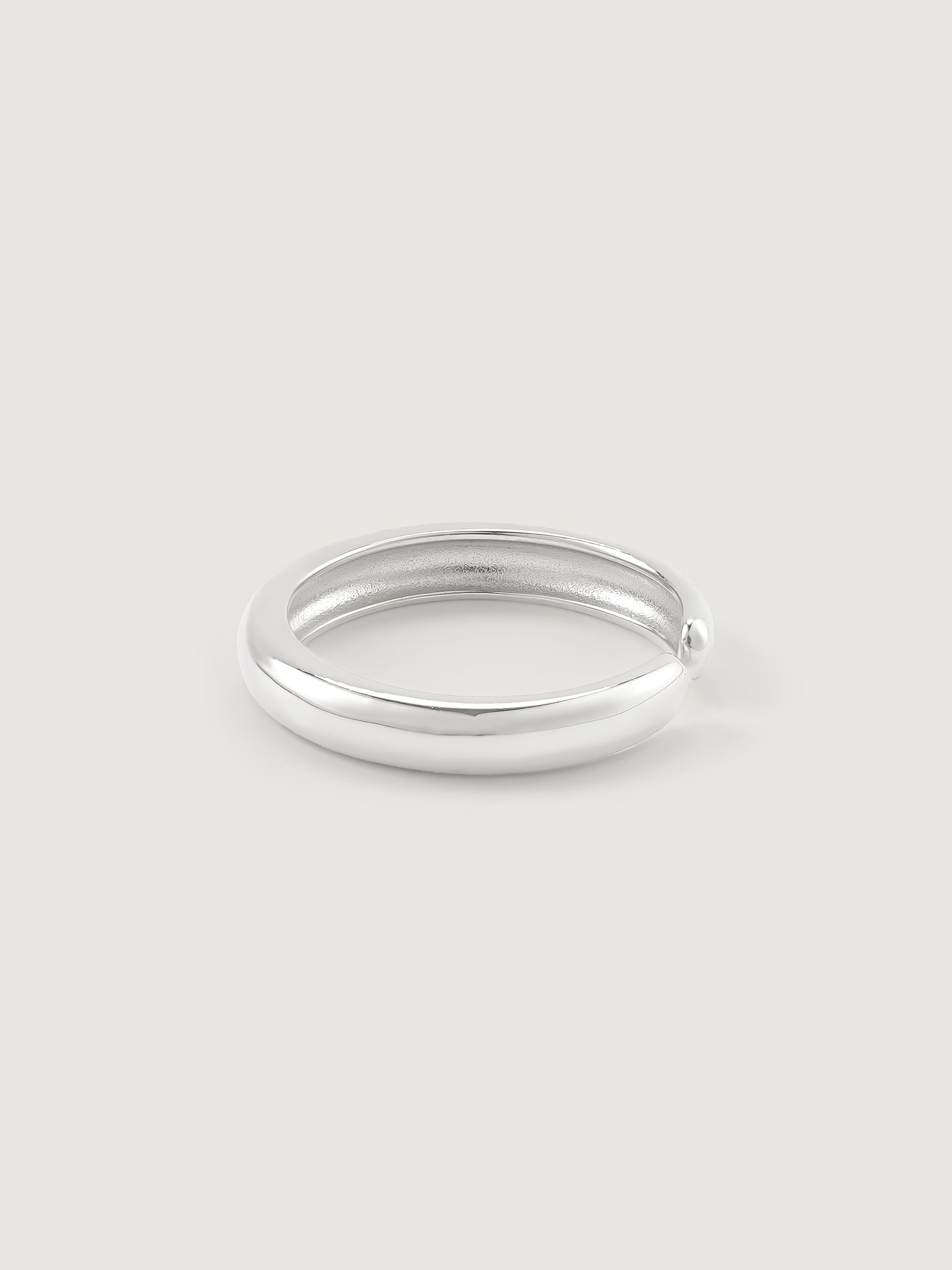Silver ring on a light gray background