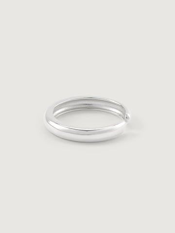Silver ring on a light gray background