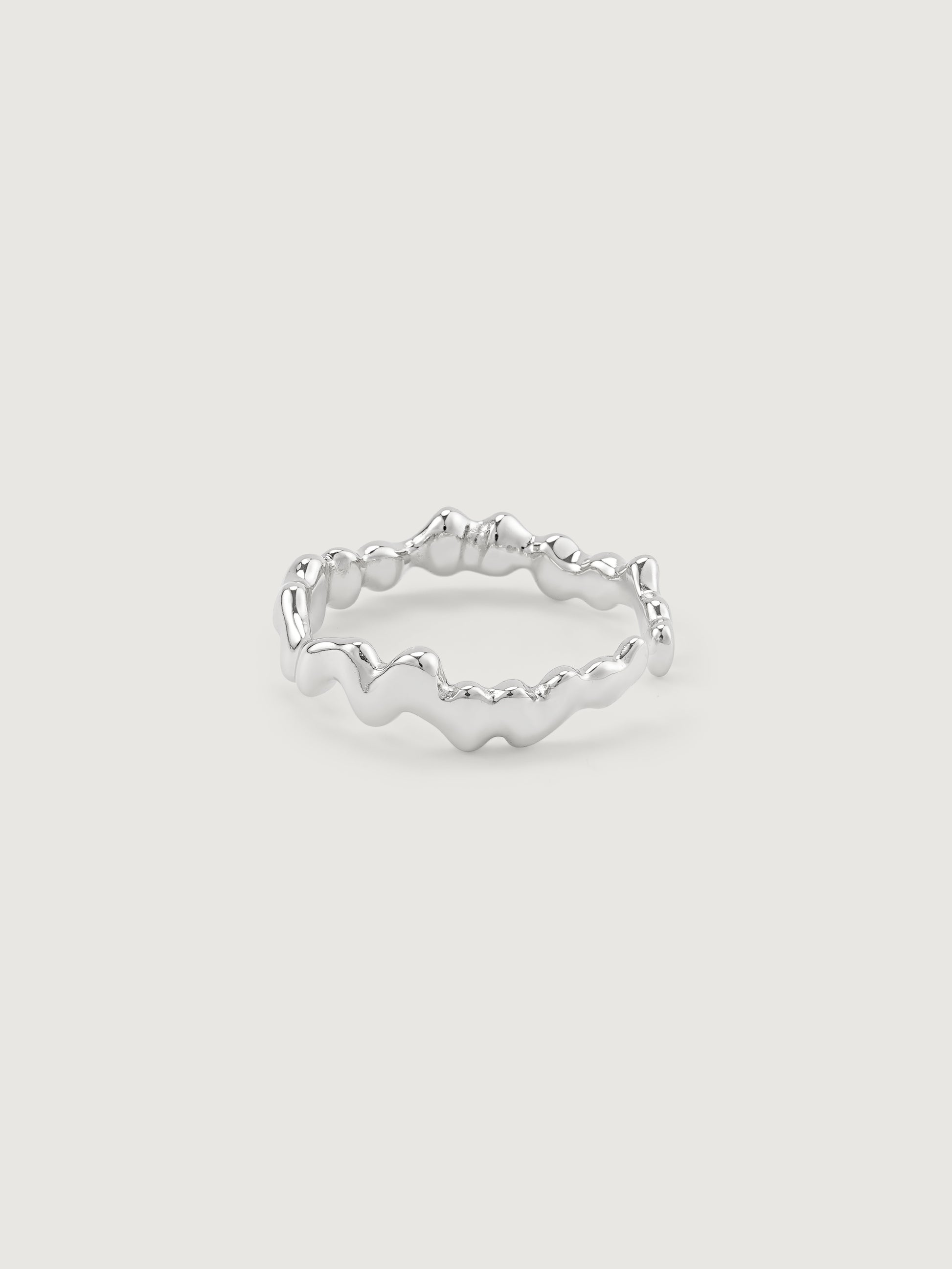 Silver ring with a textured weave design on a light gray background