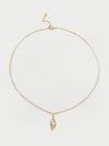 Gold necklace with a pendant on a light gray background