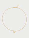 Gold necklace with a small leaf-like (also heart-like) pendant on a light gray background