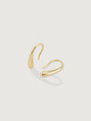 Gold hoop earring on a light gray background